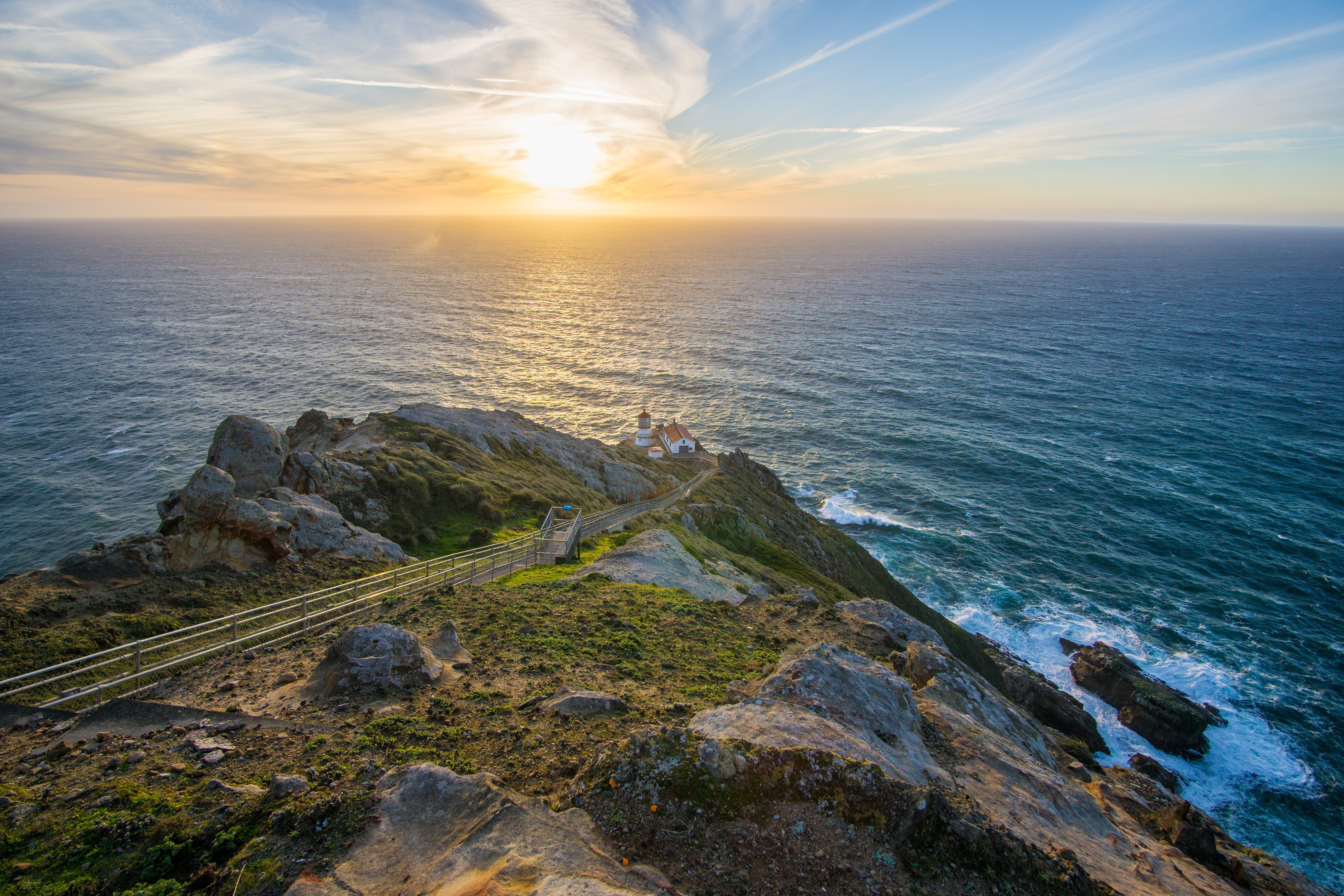 The historic Point Reyes Lighthouse and adjacent structures at the base of the 313-step stairway at sunset / NPS