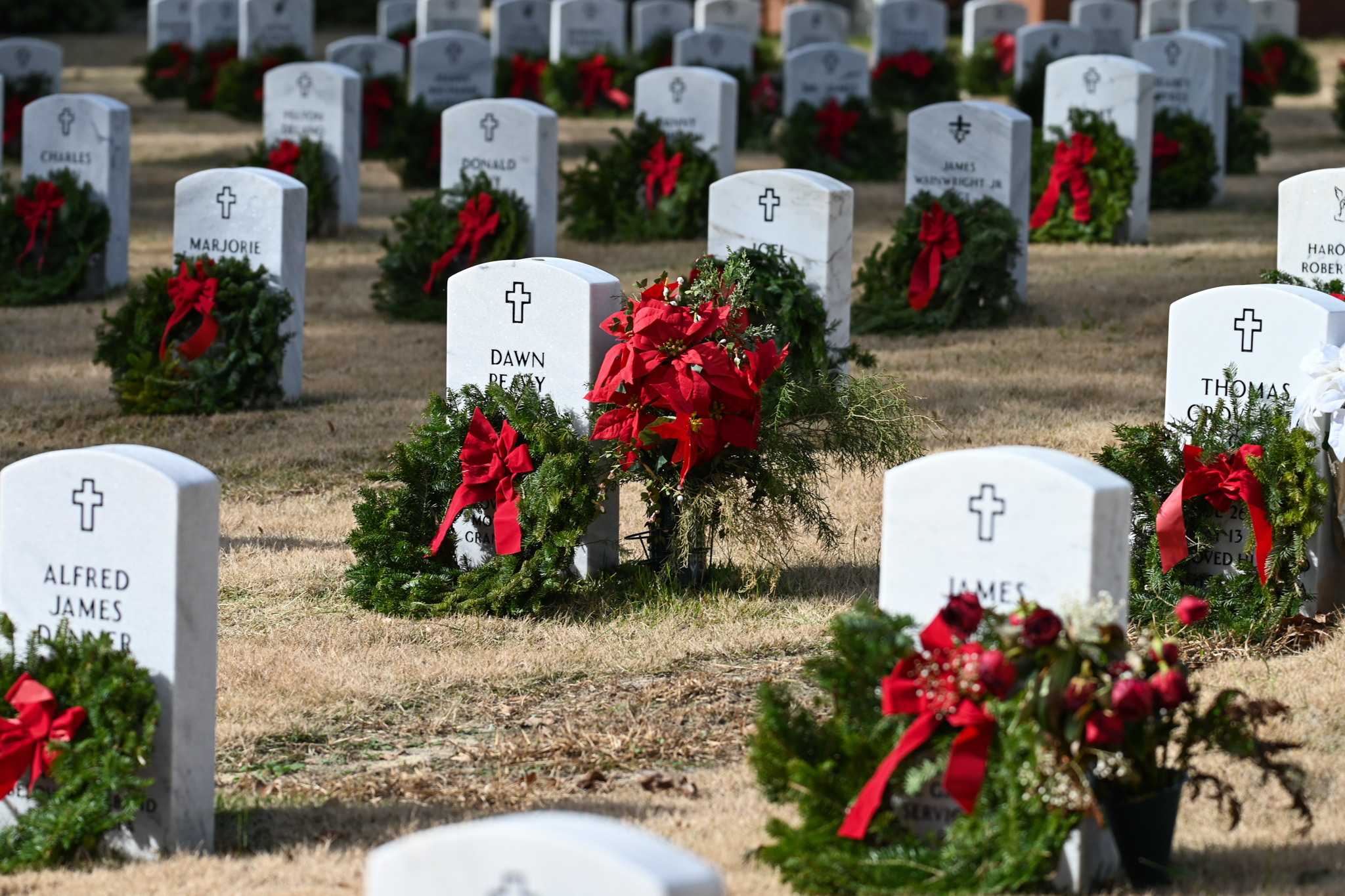 Rows of headstones with wreaths