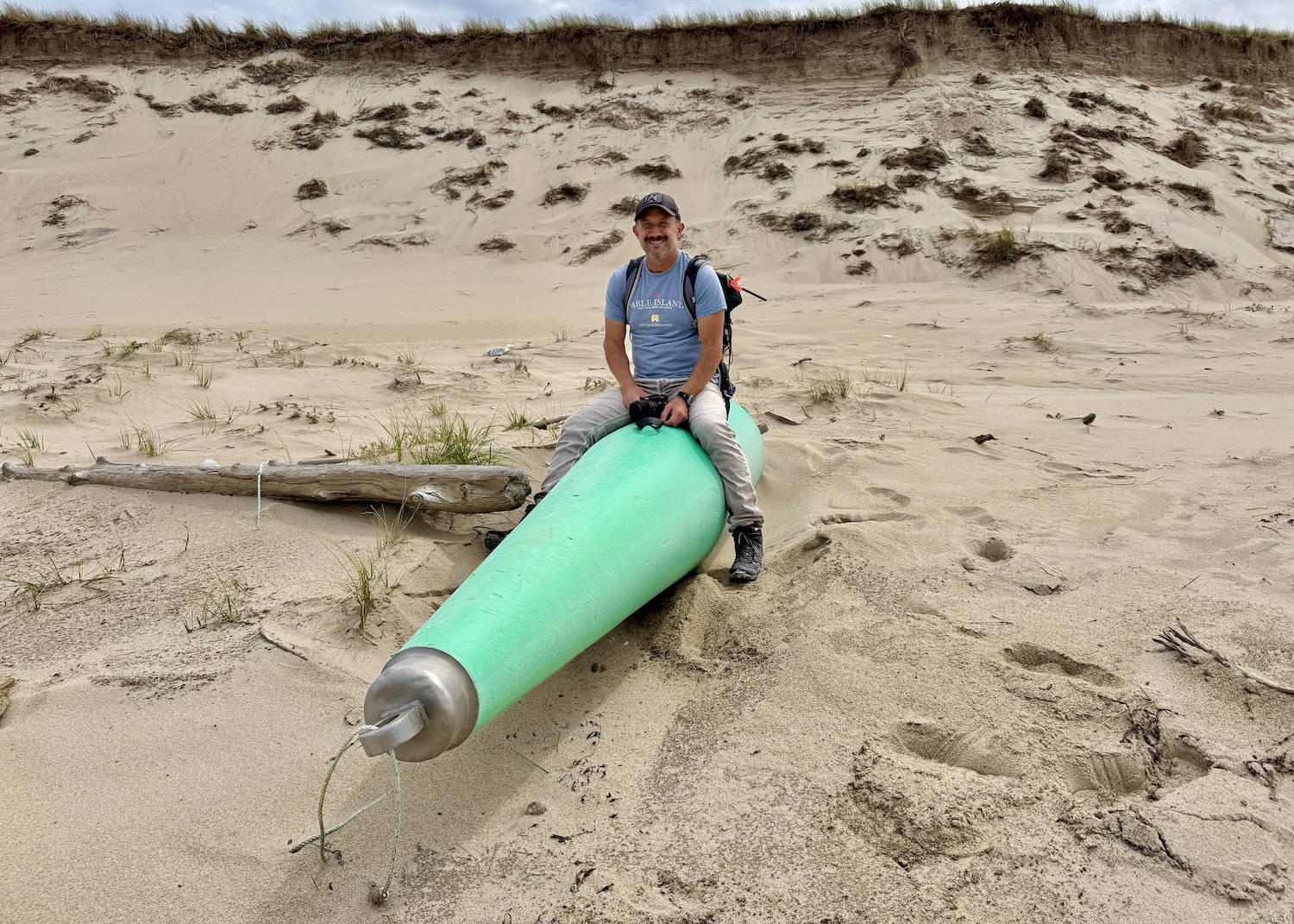 Fred Stillman sits on marine debris.