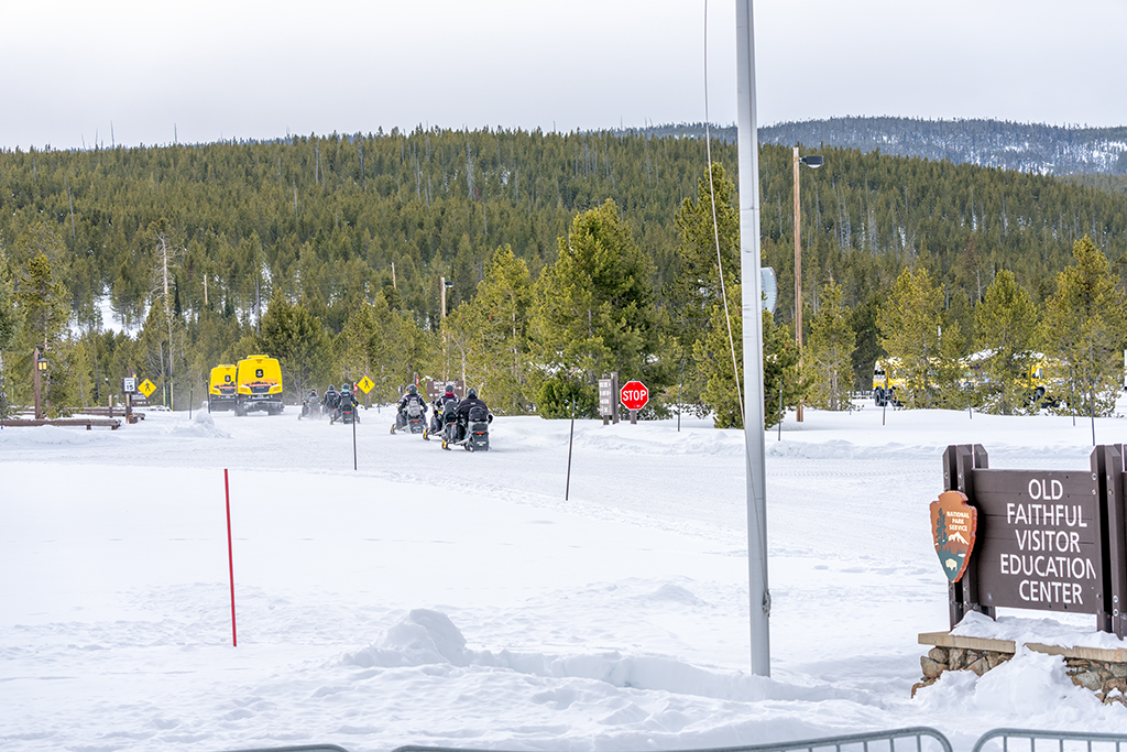 Snowcoaches and snowmobiles departing Upper Geyser Basin, Yellowstone National Park / Rebecca Latson