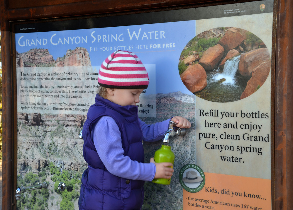 A child fills up a water bottle at a refilling station
