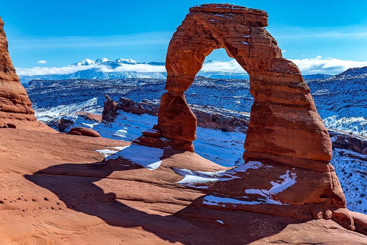 Winter's white and Arches red at Delicate Arch/Rebecca Latson