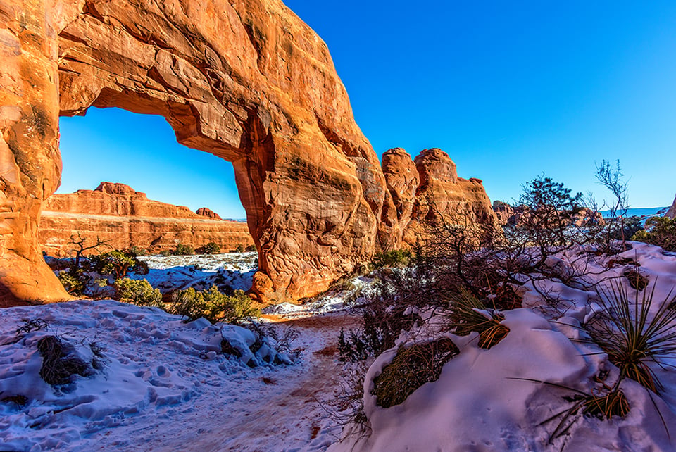 A winter view of Pine Tree Arch, Arches National Park / Rebecca Latson A winter view of Pine Tree Arch, Arches National Park / Rebecca Latson