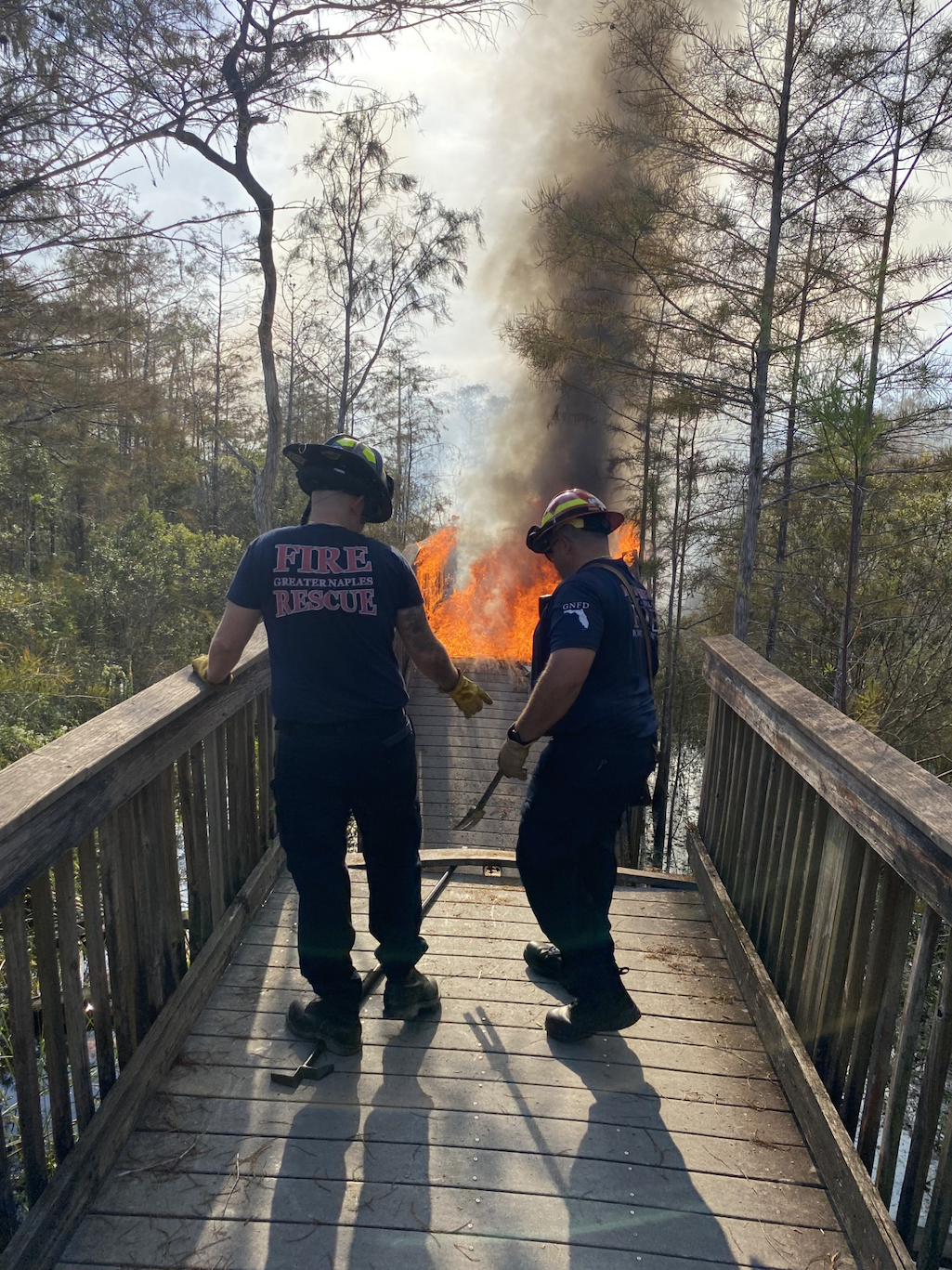 Two firefighters work to stop the fire from spreading down Kirby Storter boardwalk/NPS Two firefighters work to stop the fire from spreading down Kirby Storter boardwalk/NPS