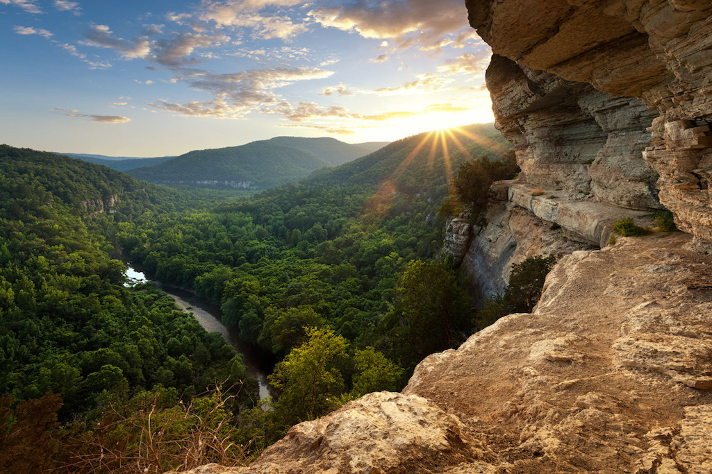 The sun sets over an expansive view of the Ponca Wilderness from a narrow bluff ledge/Aaron Bates via NPS