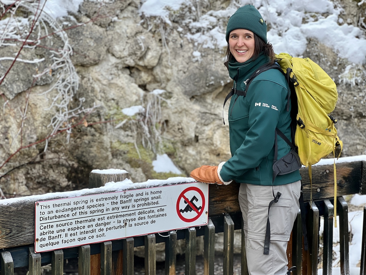 Resource conservation officer Kate Keenan stands by a warning sign that protects endangered Banff Springs Snails in Cave and Basin National Historic Site. Resource conservation officer Kate Keenan stands by a warning sign that protects endangered Banff Springs Snails in Cave and Basin National Historic Site.