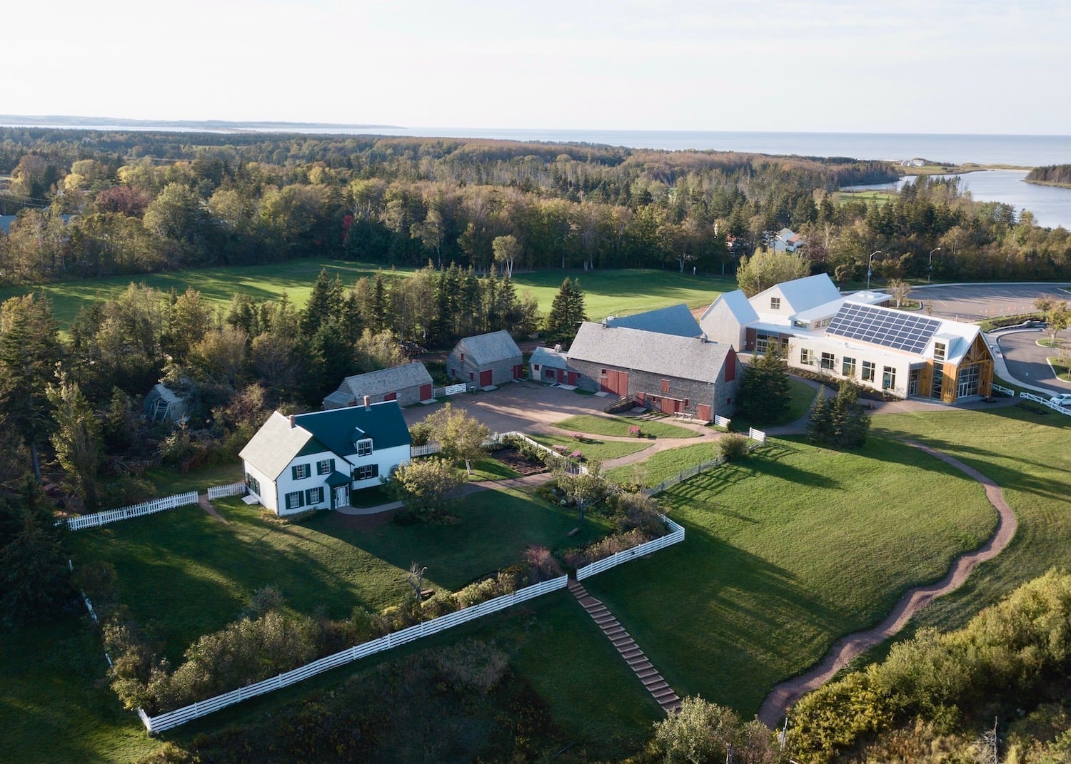 A drone captures an overview of Green Gables Heritage Place in Prince Edward Island, a site that celebrates author L.M. Montgomery and her Anne of Green Gables book series. A drone captures an overview of Green Gables Heritage Place in Prince Edward Island, a site that celebrates author L.M. Montgomery and her Anne of Green Gables book series.