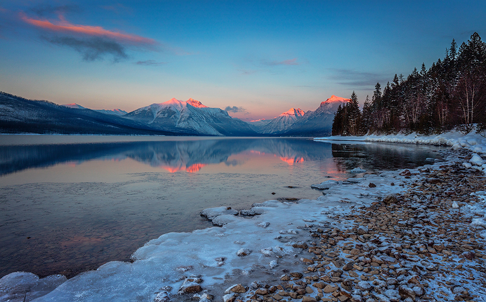 A last-ditch winter alpenglow over Lake McDonald, Glacier National Park / Rebecca Latson
