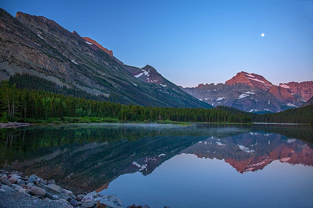 The beginning of sunrise over Mounts Gould and Grinnell at Swiftcurrent Lake, ISO 125, f/4, 1/13 second, Many Glacier Area, Glacier National Park / Rebecca Latson The beginning of sunrise over Mounts Gould and Grinnell at Swiftcurrent Lake, ISO 125, f/4, 1/13 second, Many Glacier Area, Glacier National Park / Rebecca Latson