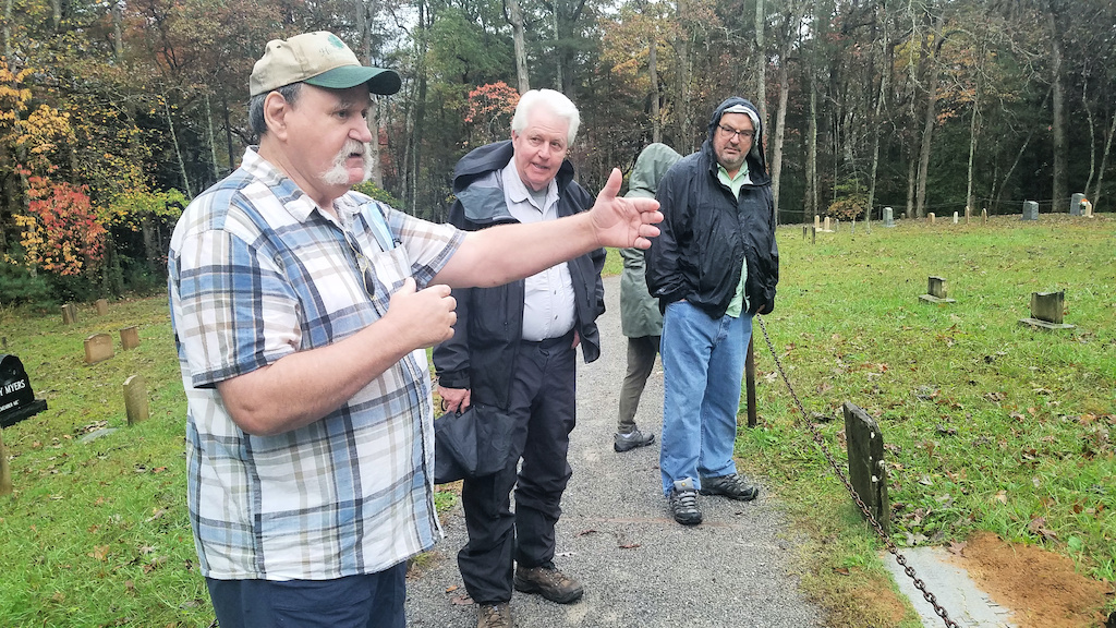 Joe Emert and other volunteers search the park's landscape for unknown military graves/Kim O'Connell