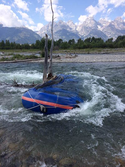 Raft snagged in Snake River in Grand Teton NP/NPS Raft snagged in Snake River in Grand Teton NP/NPS