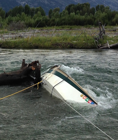 Drift boat snagged in Snake River in Grand Teton NP/NPS Drift boat snagged in Snake River in Grand Teton NP/NPS