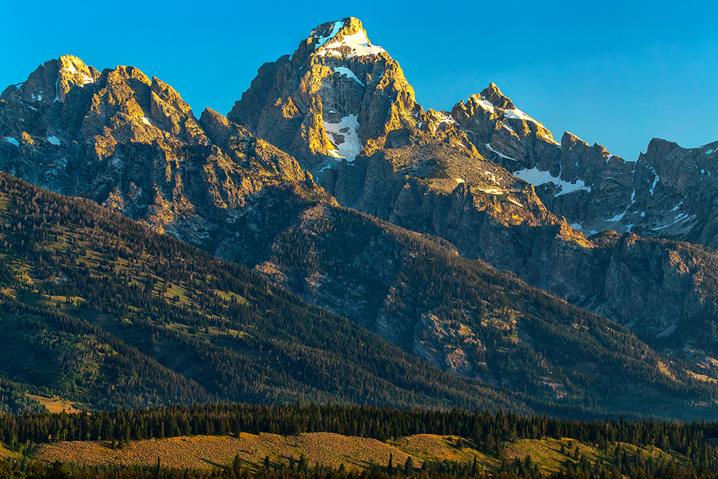 Morning sunlight over the mountains, Grand Teton National Park / Rebecca Latson