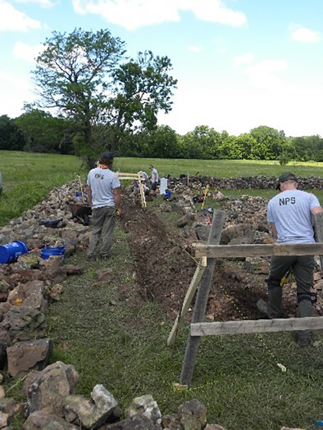 Skilled masons repairing a stone wall around the Carver Family Cemetery, George Washington Carver National Monument / NPS
