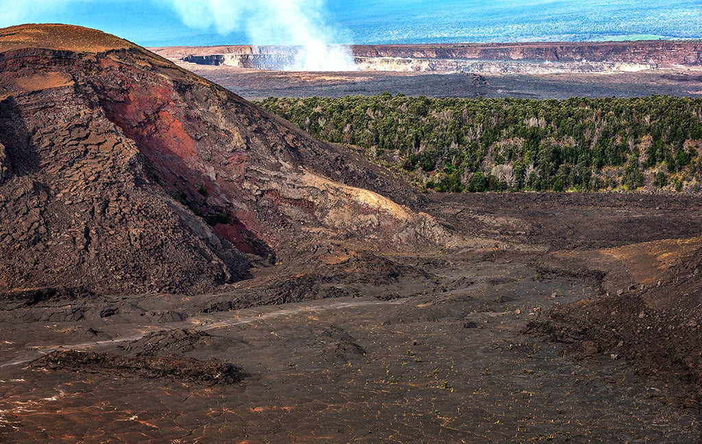 A telephoto view of the Kīlauea Iki trail, Pu'u Pua'i cinder cone, and a steaming Hale'uma'u crater in the background, Hawai'i Volcanoes National Park / Rebecca Latson
