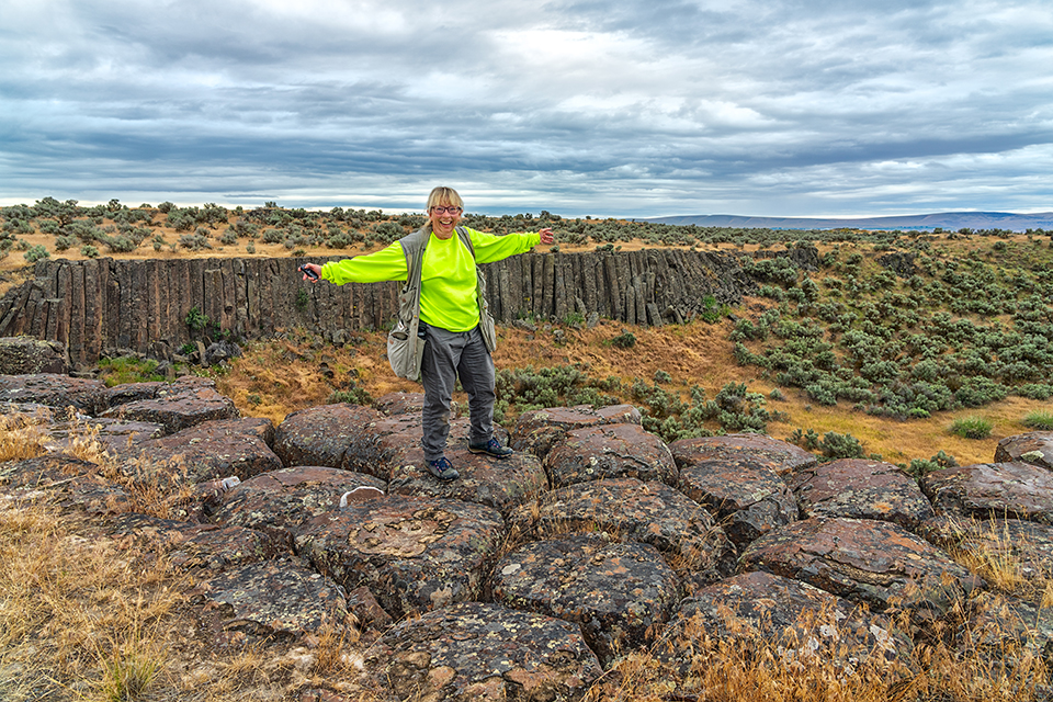 Becky standing atop some columnar basalts, Drumheller Channels National Natural Landmark, Ice Age Floods National Geologic Trail / Rebecca Latson Becky standing atop some columnar basalts, Drumheller Channels National Natural Landmark, Ice Age Floods National Geologic Trail / Rebecca Latson