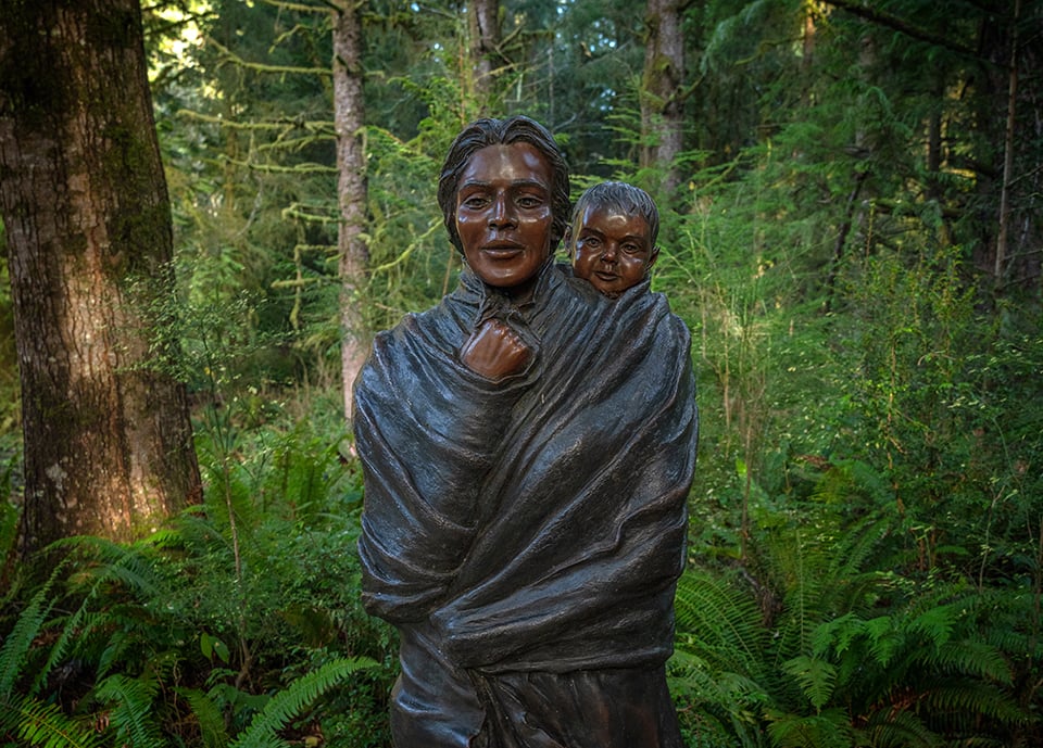 A statue of Sacagawea and her infant son along the trail to the fort, Lewis and Clark National Historical Park / Rebecca Latson A statue of Sacagawea and her infant son along the trail to the fort, Lewis and Clark National Historical Park / Rebecca Latson