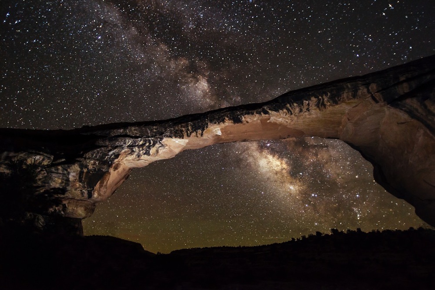 The arching rock formation known as Owachomo Bridge frames this view of the Milky Way overhead at Natural Bridges National Monument, Utah. The arching rock formation known as Owachomo Bridge frames this view of the Milky Way overhead at Natural Bridges National Monument, Utah.