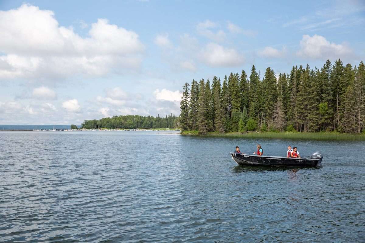 Boating on a pristine lake in Prince Albert National Park. Boating on a pristine lake in Prince Albert National Park.
