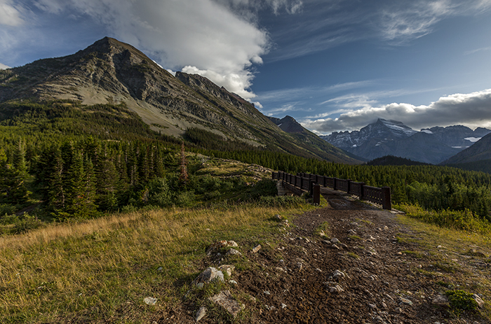 Bridge To The Mountains Of Many Glacier