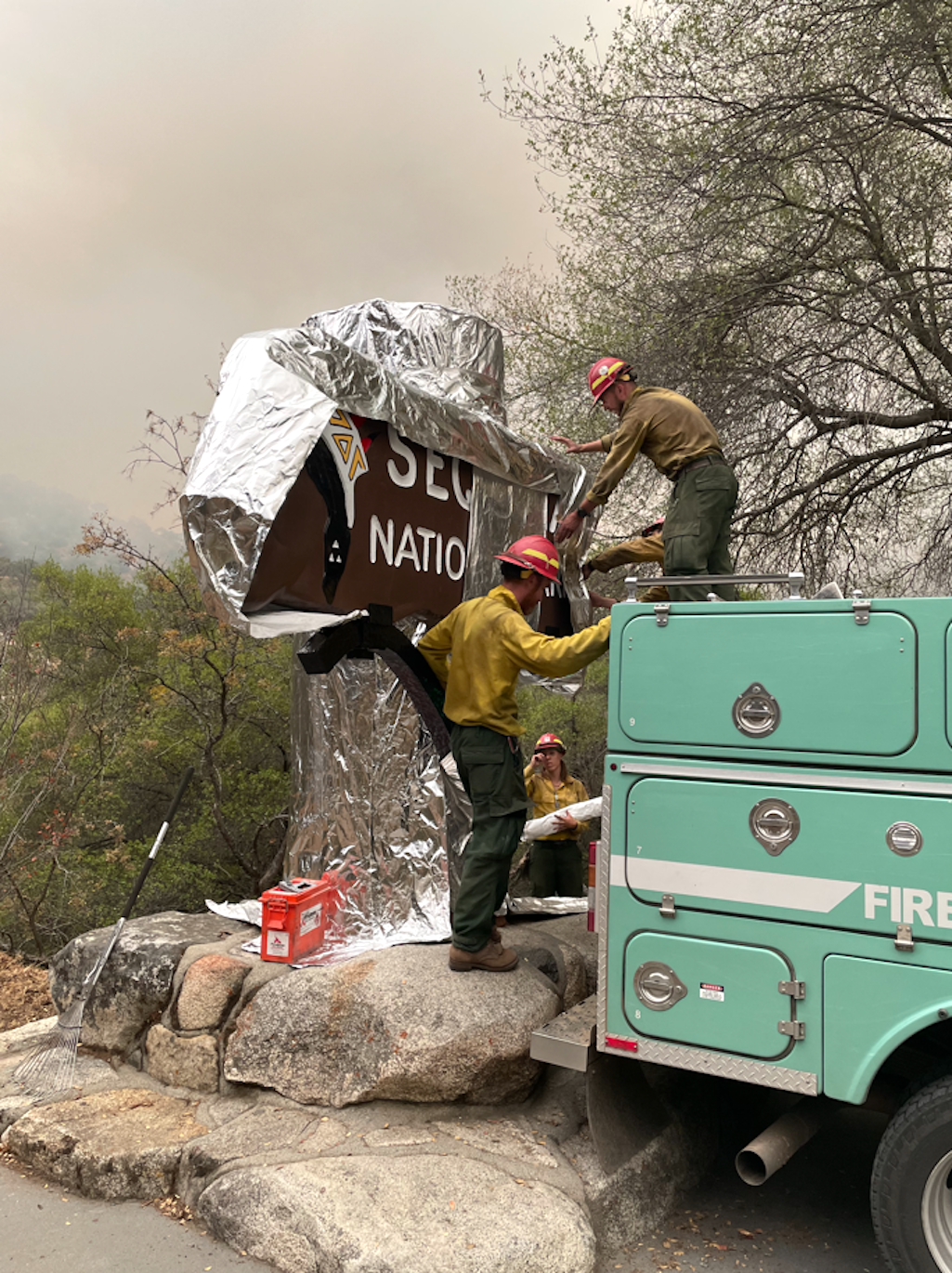 Firefighters used a heavy aluminum wrap to protect the entrance sign to Sequoia National Park, and to wrap the base of some giant sequoia trees/NPS