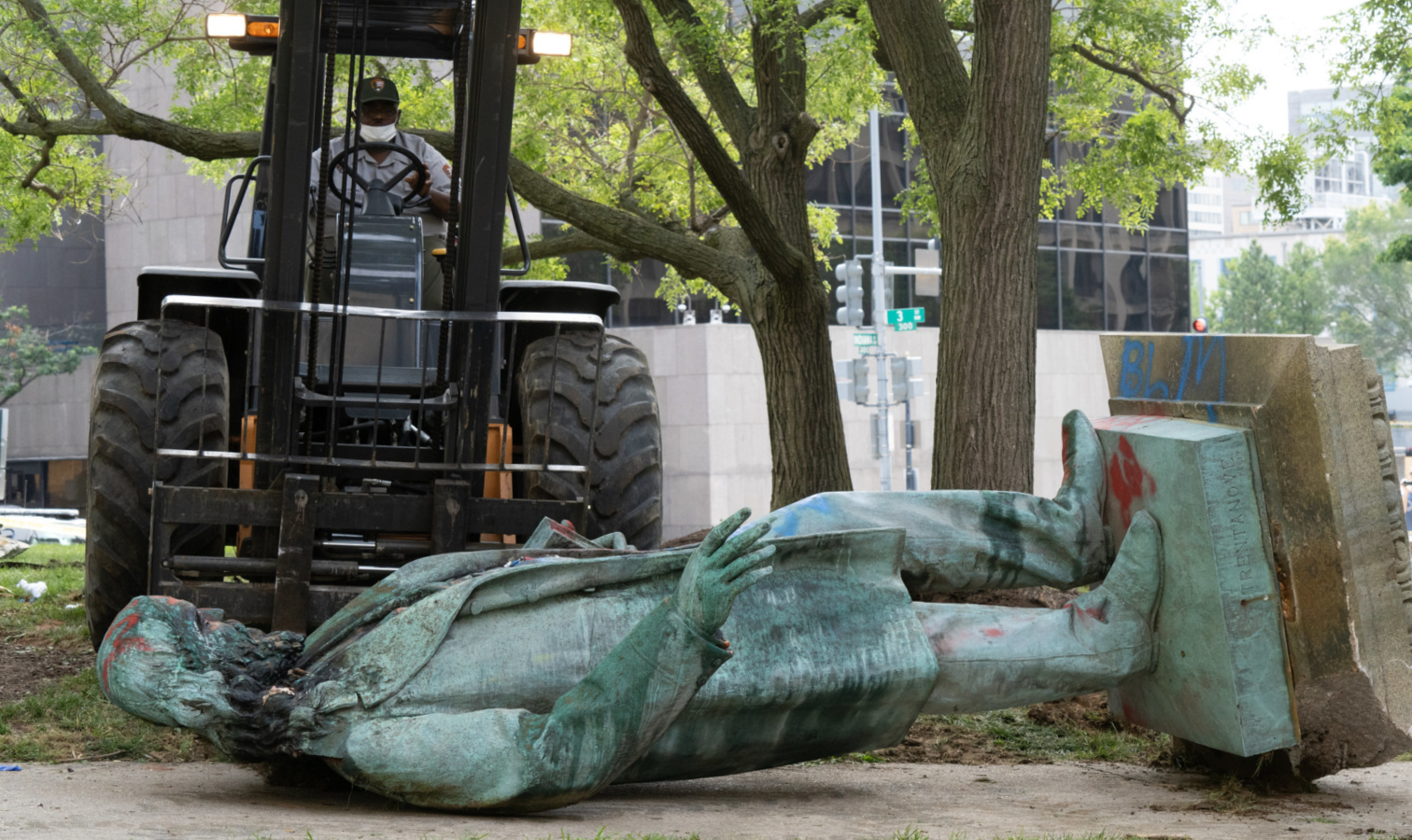 Albert Pike statue on the ground after being toppled from its pedestal