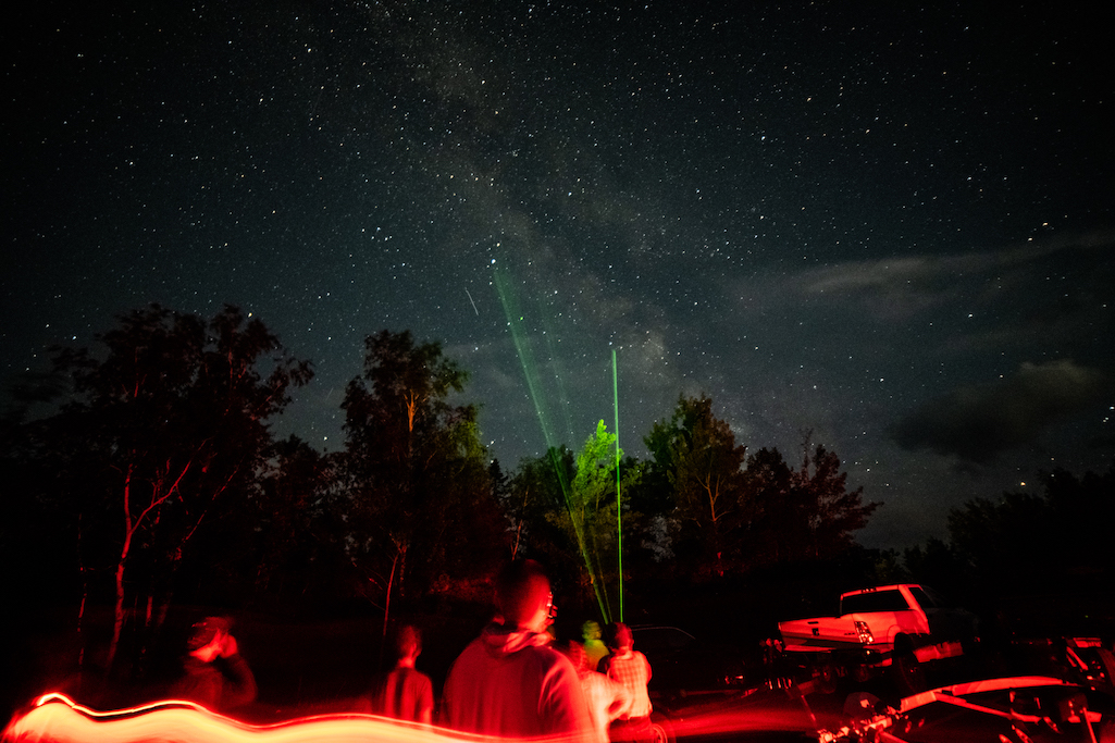 Green laser pointers are used to point out constellations at Voyageurs National Park's star party/NPS file