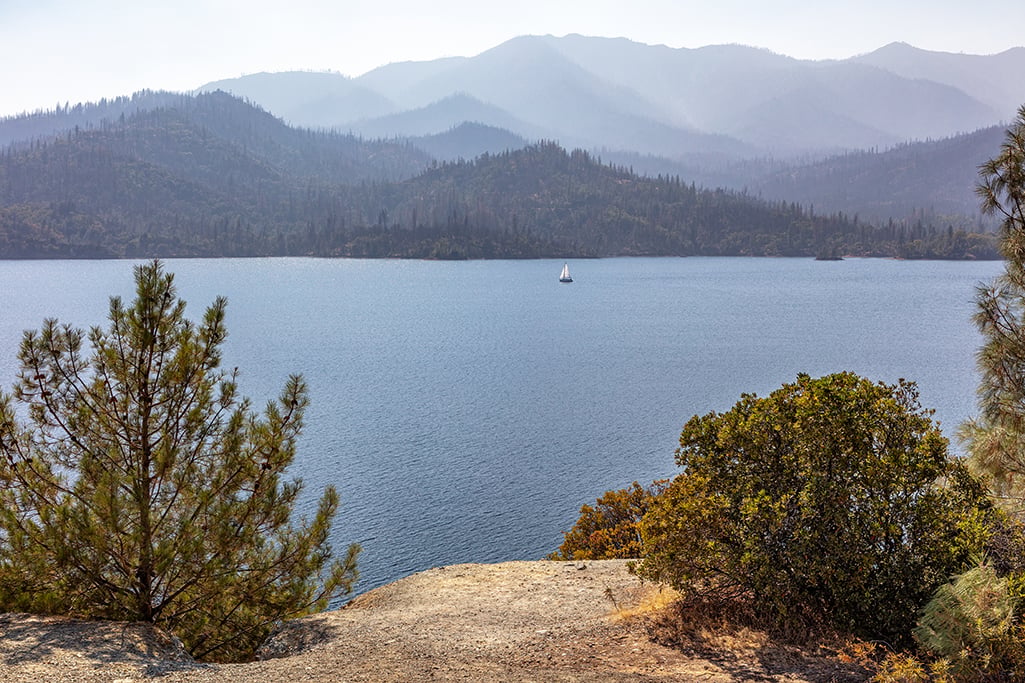 Serene sailing under a smoky sky on Whiskeytown Lake, Whiskeytown National Recreation Area / Rebecca Latson