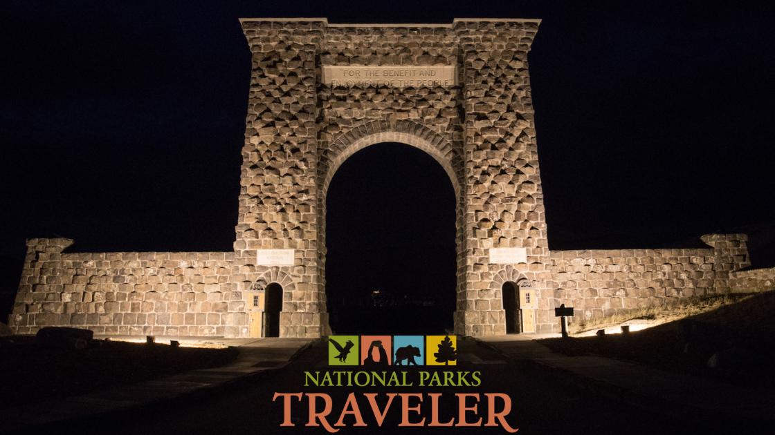 A night time image of the Roosevelt Arch in Yellowstone National Park
