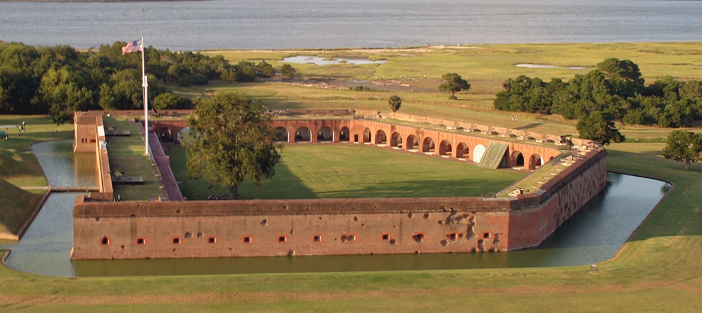 An aerial view of the pentagon-shaped Fort Pulaski surrounded by a moat, Fort Pulaski National Monument