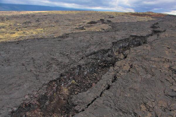 Color photograph of crack in the ground surface