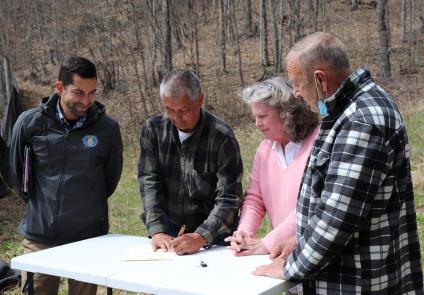 Cherokee leaders sign an agreement to create a test orchard for American chestnuts. 
