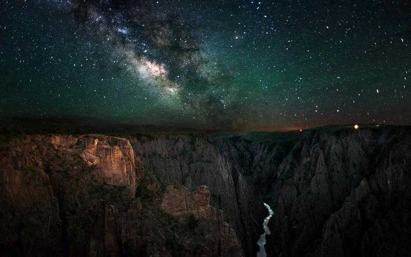 A dark sky with a bright Milky Way over the Black Canyon of the Gunnison National Park