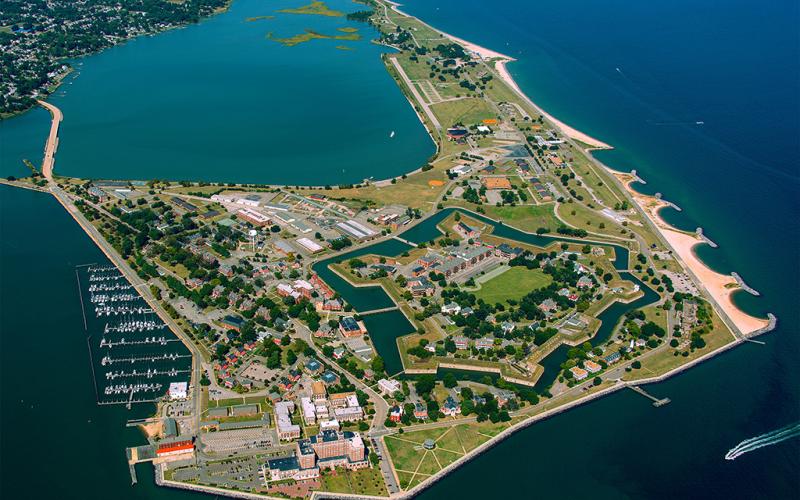 An aerial view of a fort surrounded by water with a marina on one side and a beach on the other at Fort Monroe National Monument