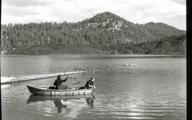 A black-and-white photo circa 1941 of two women in a boat fishing on Butte Lake in Lassen Volcanic National Park