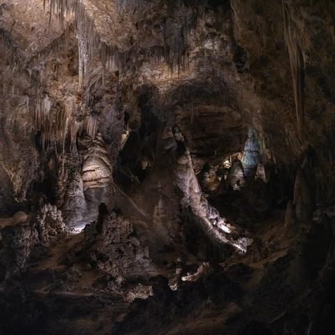 Stalactites and large stalagmites with flowstone drapery seen along the Big Room Trail at Carlsbad Caverns National Park
