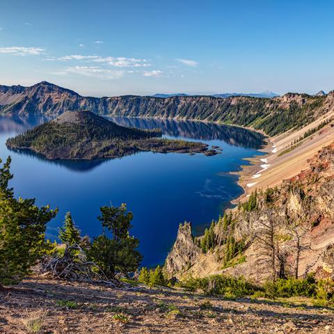 A view of wizard island and deep blue lake water at Crater Lake National Park