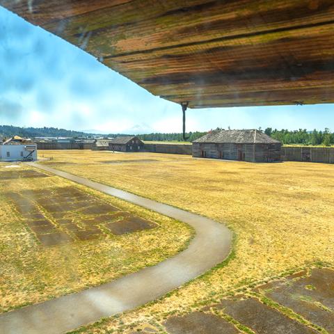 A view from a somewhat spotted window of the Bastion looking out onto the grounds of Fort Vancouver National Historic Site.