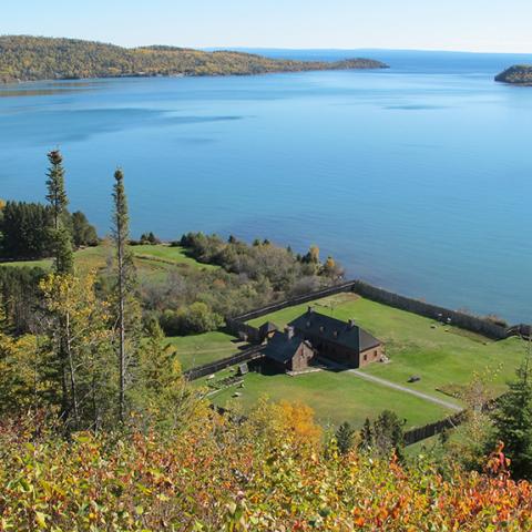 A view of Lake Superior and historical buildings from the Mount Rose Trail Overlook at Grand Portage National Monument