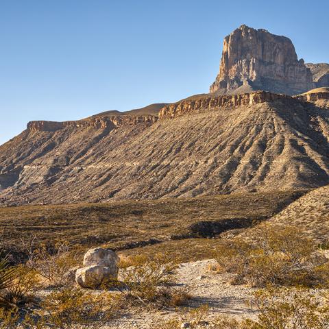 Late afternoon sunlight shining over a wide-angle view of the iconic El Capitan and surrounding landscape at Guadalupe Mountains National Park