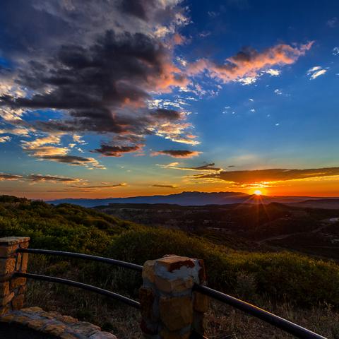 A colorful sunrise with mountains and clouds at Park Point overlook in Mesa Verde National Park