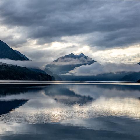 Lake Crescent in Olympic National Park, with mountains in the background wreathed in clouds