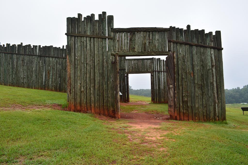 Wooden gates and walls on the side of a sloping hill at Andersonville National Historic Site.