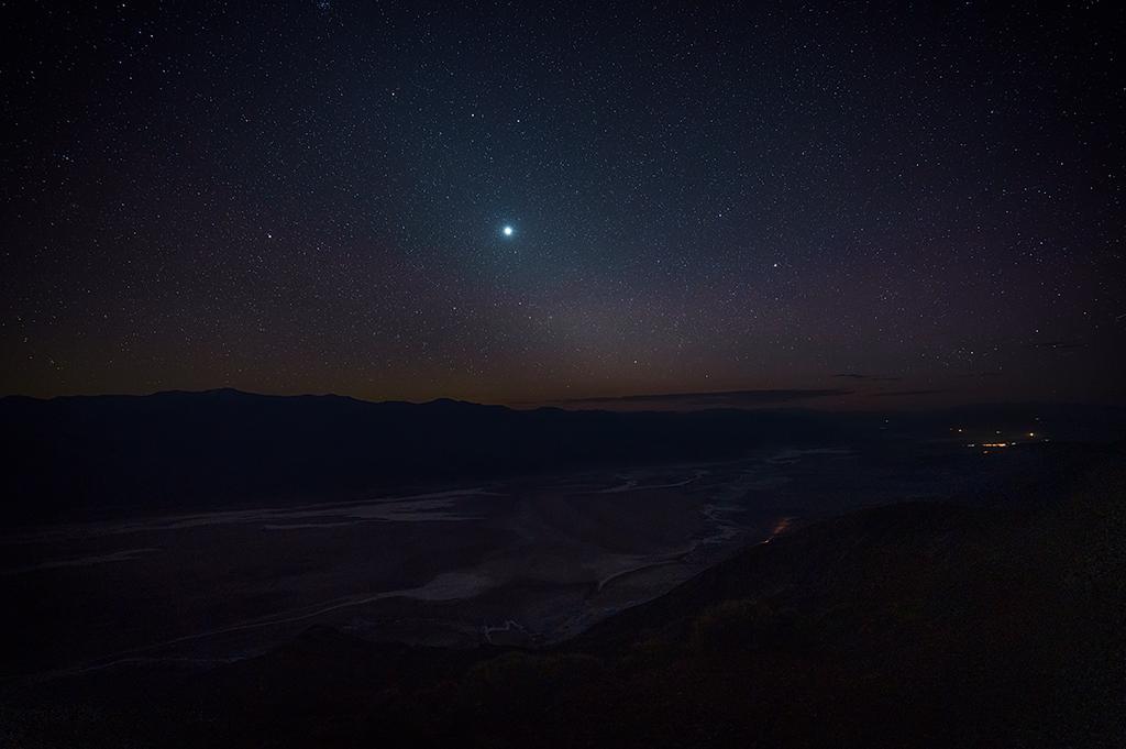 A starry night sky over Badwater Basin and the Panamint Mountains as seen from Dantes View, Death Valley National Park