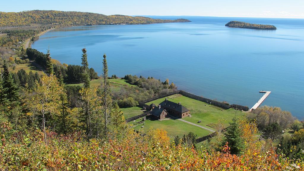 A view of Lake Superior and historical buildings from the Mount Rose Trail Overlook at Grand Portage National Monument