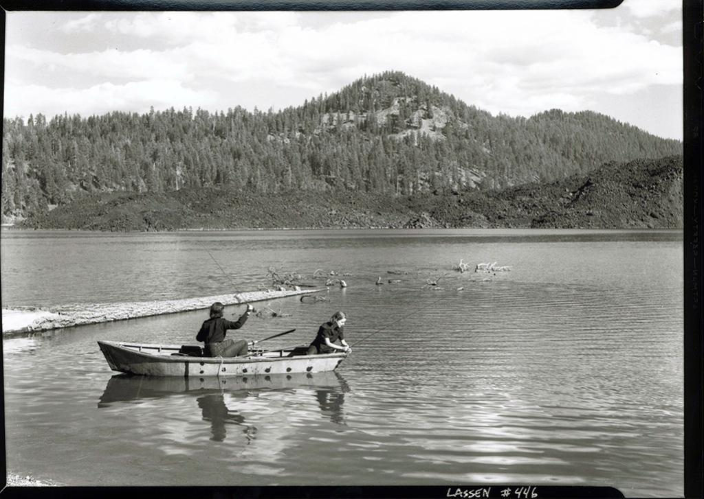 A black-and-white photo circa 1941 of two women in a boat fishing on Butte Lake in Lassen Volcanic National Park