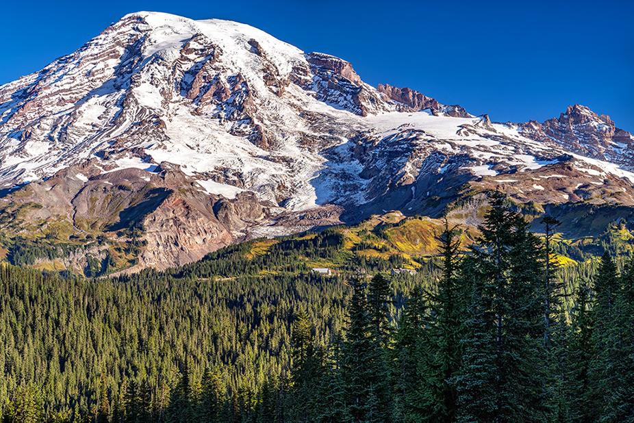 A distant view of the Paradise area, including parking lot and buildings, along with Nisqually Glacier as seen from the Pinnacle Peak Trail, Mount Rainier National Park, Washington