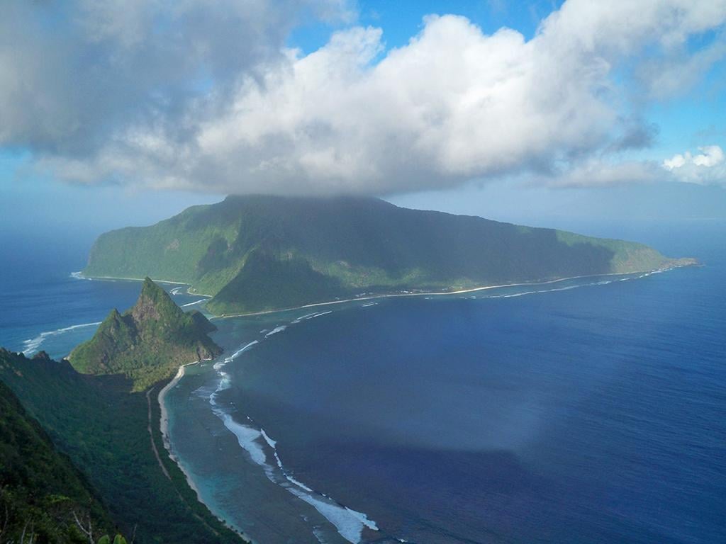 An aerial view of a blue ocean arc around Ofu and Olosega islands, National Park of American Samoa
