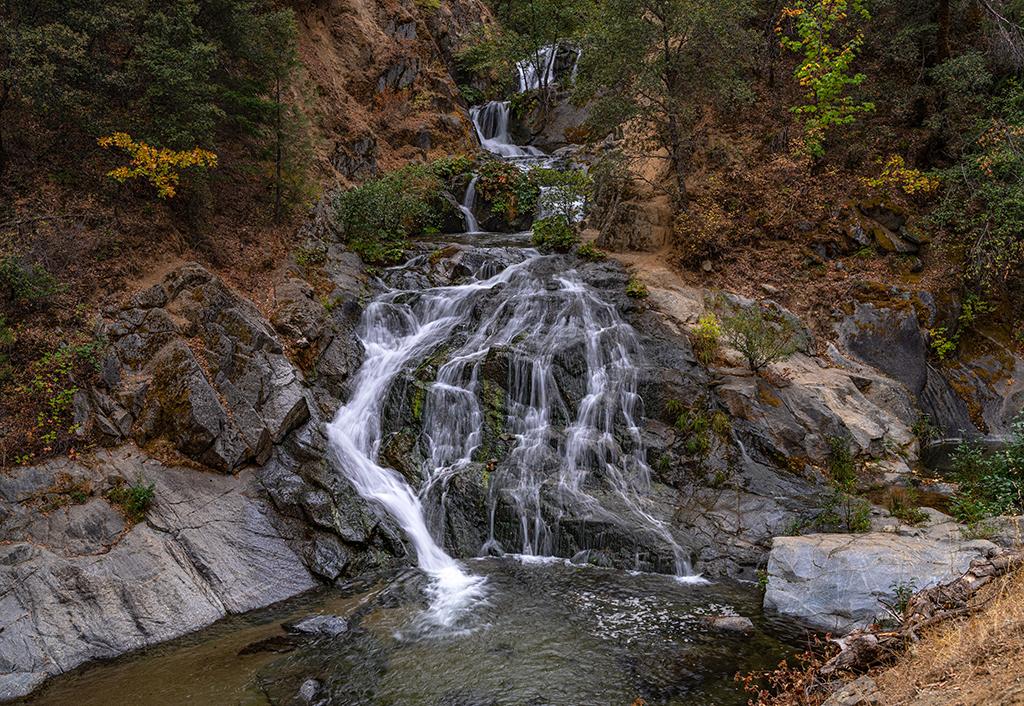 The silky water cascade of Crystal Creek Falls over grayish rock on an autumn morning, Whiskeytown National Recreation Area