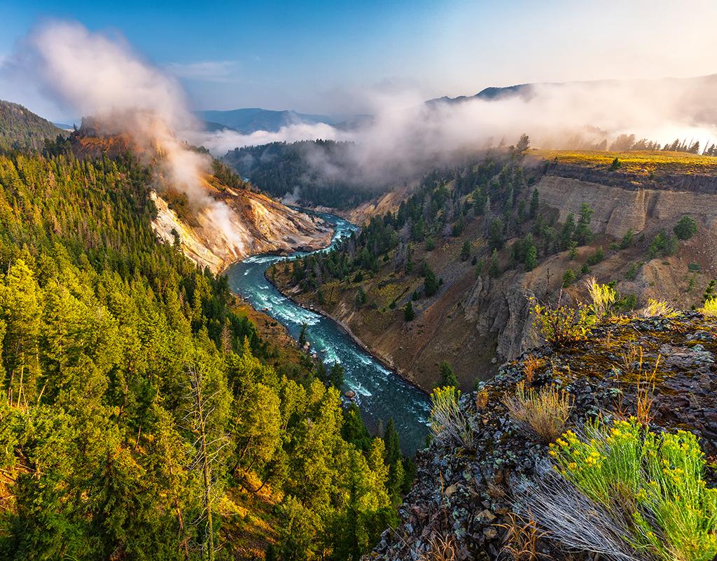 Calcite Springs Overlook with a view to the Yellowstone River and steaming vents on a summer morning.